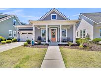 Charming single-story home with a welcoming front porch, beautiful landscaping, and a nicely paved walkway at 3529 Habenaria Rd # 33, Mount Pleasant, SC 29466