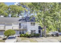Charming two-story townhouse with a balcony, well-maintained landscaping, and ample parking at 4662 Nibbs Ln, North Charleston, SC 29418
