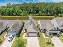 An aerial view of the house, showing the lake and fountain behind the house at 548 Sea Foam St, Summerville, SC 29486