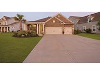 Charming brick home featuring a manicured lawn, a two-car garage and beautiful landscaping at 627 Chigwell Springs Ln, Summerville, SC 29486