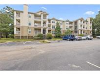 Multi-level condominium building with outdoor balconies and parking area at 700 Daniel Ellis Dr # 11302, Charleston, SC 29412