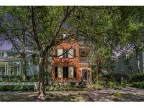 Charming two-story home with wood siding, a covered balcony, and lush landscaping at 82 Ponsbury Rd, Mount Pleasant, SC 29464