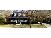Charming single Gathering home featuring a brick facade, dormer windows, and a cozy front porch with white railing at 970 Pine Hollow Rd, Mount Pleasant, SC 29464