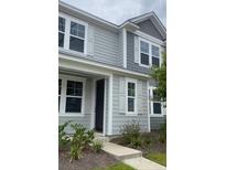 Charming two-story home boasts a stylish gray exterior and inviting white window shutters at 111 Brant Dr, Summerville, SC 29483