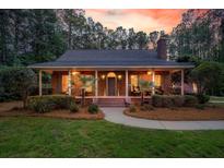 Charming brick home featuring a welcoming front porch and meticulously manicured landscaping at 152 Candace Dr, Ridgeville, SC 29472