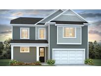 Charming two-story home with an attached two car garage and manicured front yard at 191 E Pinckney St, Summerville, SC 29485