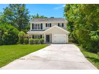 Charming two-story home features a long driveway, one car garage and well-maintained lawn surrounded by mature trees at 214 Blackstone Dr, Moncks Corner, SC 29461