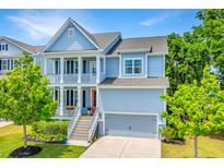 Charming two-story home featuring double porches, a grey garage door, and manicured landscaping at 2234 Mother Of Pearl Dr, Mount Pleasant, SC 29466