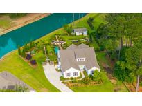 Stunning aerial view of the home with lush landscaping, a lovely garden, and a serene waterfront at 225 Camber Rd, Huger, SC 29450
