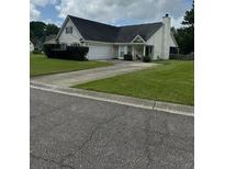 Charming single-story home with a well-manicured lawn and attached two-car garage in a peaceful neighborhood at 2709 Palmetto Hall Blvd, Mount Pleasant, SC 29466