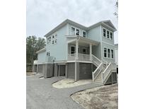 Charming, elevated two-story home featuring light blue siding and white trim accents at 2790 Burden Creek Rd, Johns Island, SC 29455