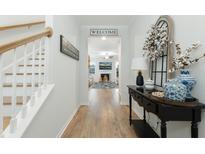 Welcoming entryway with wood floors, white trim, and decorative accents, leading into the spacious living area at 297 Red Leaf Blvd, Moncks Corner, SC 29461