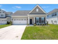Charming single-Gathering home with a two-car garage and well-maintained lawn, creating curb appeal at 341 Witch Hazel St, Summerville, SC 29486