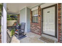 Charming front porch featuring rocking chairs and brick accents, inviting relaxation and curb appeal at 406 Carolina Cir, Ladson, SC 29456