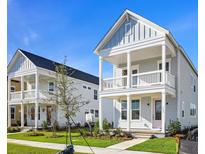 Charming two-story home with a welcoming front porch and a beautifully landscaped yard in a modern neighborhood at 515 Ivy Green Ln, Summerville, SC 29486