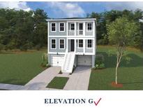 Charming three-story home with a two-car garage, white stairs, and gray siding, nestled among mature trees at 754 Minton Rd, Charleston, SC 29414