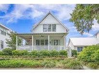 Charming two-story home features a welcoming front porch and manicured landscaping at 7935 Flagship Ln, Johns Island, SC 29455