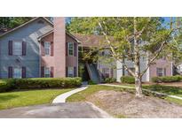 Inviting multi-level condo with manicured landscaping and classic shuttered windows at 7945 Parklane Ct # C, North Charleston, SC 29418