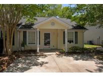 Charming single-story home featuring a cozy front porch, manicured landscaping, and a well-maintained yard at 7947 Vermont Rd, North Charleston, SC 29418