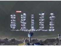 Aerial view of a marina with numerous boats docked in slips, some labeled as B-11 at We 10Th St # B11, Folly Beach, SC 29439
