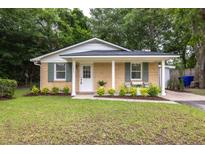 Charming single-story brick home with a well-manicured lawn, neutral paint, and inviting curb appeal at 1010 Fiall St, Charleston, SC 29407