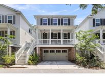 Charming two-story home with a brick-accented garage and a welcoming front porch at 1093 Ave Of Oaks, Charleston, SC 29407