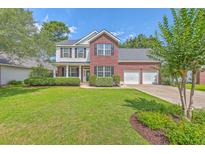 Charming two-story home with a well-manicured lawn and attached two-car garage at 111 Kapalua Run, Summerville, SC 29483