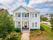 Charming two-story home with a double porch, landscaped yard, and classic Lowcountry design at 1446 Crane Creek Dr, Mount Pleasant, SC 29466