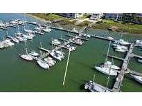Scenic aerial view of a marina featuring a variety of boats docked in tranquil green waters at 2 Mcdonough Rd # B-11, Folly Beach, SC 29439