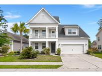Charming two-story home featuring a double front porch, landscaped yard, and two-car garage at 203 Yeamans Way, Summerville, SC 29483