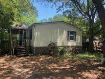 Charming single-story home with mature trees, complemented by a cozy porch and a well-kept yard at 2041 Covey Ln, Charleston, SC 29412