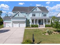 Charming two-story home with a welcoming front porch, three car garage and a nicely manicured front yard at 2917 River Vista Way, Mount Pleasant, SC 29466