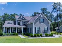 Charming two-story home with a landscaped front yard and inviting covered porch at 3025 Rampart Rd, Summerville, SC 29483