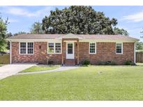 Charming brick home featuring a manicured lawn, inviting walkway, and classic architectural details at 334 Water Oak Dr, Goose Creek, SC 29445