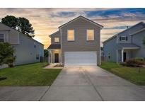 Charming two-story home with a well-maintained lawn and attached two-car garage at 354 Iveson Rd, Summerville, SC 29486