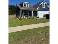 Charming home with a well-manicured lawn and inviting front porch at 359 Whispering Breeze Ln, Summerville, SC 29486