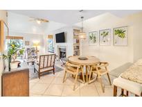 Bright living room features a stone fireplace and dining area, perfect for entertaining at 4403 Sea Forest Dr, Kiawah Island, SC 29455