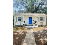 Charming single-story home with a blue front door, gray shutters, and a well-manicured front yard at 4406 Holmes Ave, North Charleston, SC 29405
