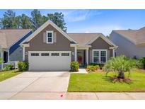 Charming single story home with landscaped yard and a two car garage at 5078 Song Sparrow Way, Summerville, SC 29483