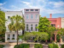 Charming Charleston home with a colorful facade, lovely landscaping, and curb appeal at 71 E Bay St, Charleston, SC 29401