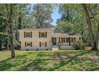 Charming two-story home with well-maintained lawn, mature trees, and inviting front porch at 7639 Hillandale Rd, North Charleston, SC 29420