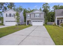 Charming two-story home featuring a driveway and a well-maintained lawn at 849 Kirby Ct, Charleston, SC 29414