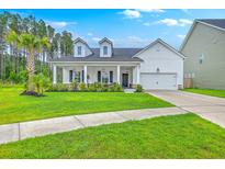 Charming single-Gathering home featuring a well-manicured lawn, covered porch with seating, and white exterior at 1059 Fitzgerald Ct, Summerville, SC 29485