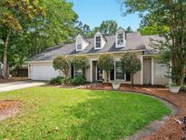 Charming one-story home featuring a manicured lawn and a two-car garage at 113 Mapperton Ct, Summerville, SC 29485