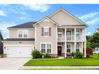 Charming two-story home with a manicured lawn, a two-car garage, and a cozy front porch at 175 Basket Grass Ln, Summerville, SC 29486