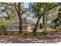 Charming single-story home with mature landscaping and a welcoming front entrance and cozy curb appeal at 2105 Loblolly Ln, Seabrook Island, SC 29455