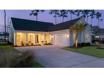 Charming single-story home with an attached garage, inviting front porch, and a well-manicured lawn at 357 Tupelo Lake Dr, Summerville, SC 29486