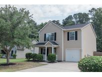 Charming two-story home with black shutters, a well-manicured lawn, and an attached one-car garage at 5094 Thornton Dr, Summerville, SC 29485