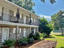 Charming two-story apartment building with well-maintained landscaping and iron railing balconies at 516 Arlington Dr # B5, Charleston, SC 29414