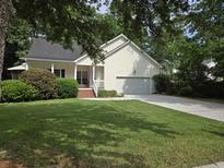 Charming home featuring a well-manicured lawn and a welcoming front porch, offering great curb appeal at 5347 Sundial Ct, North Charleston, SC 29418
